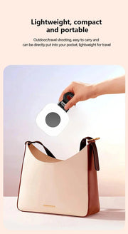Mini LED smartphone selfie fill light being clipped into a compact handbag, showcasing its portability and lightweight design for travel.