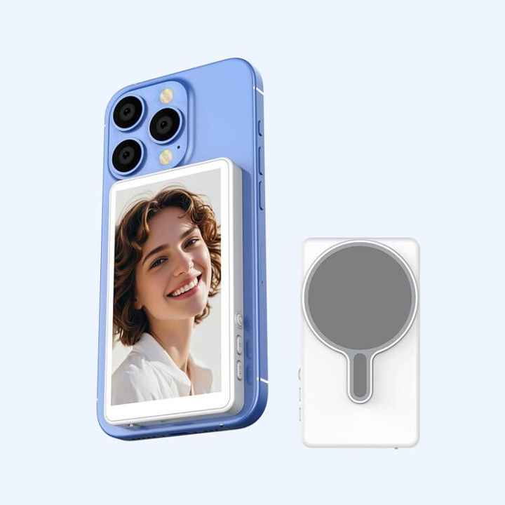 CamBuddyPro™ Magnetic Wireless Selfie Monitor attached to a blue smartphone showing a live rear camera preview with a smiling woman, next to the wireless magnetic mount device.
